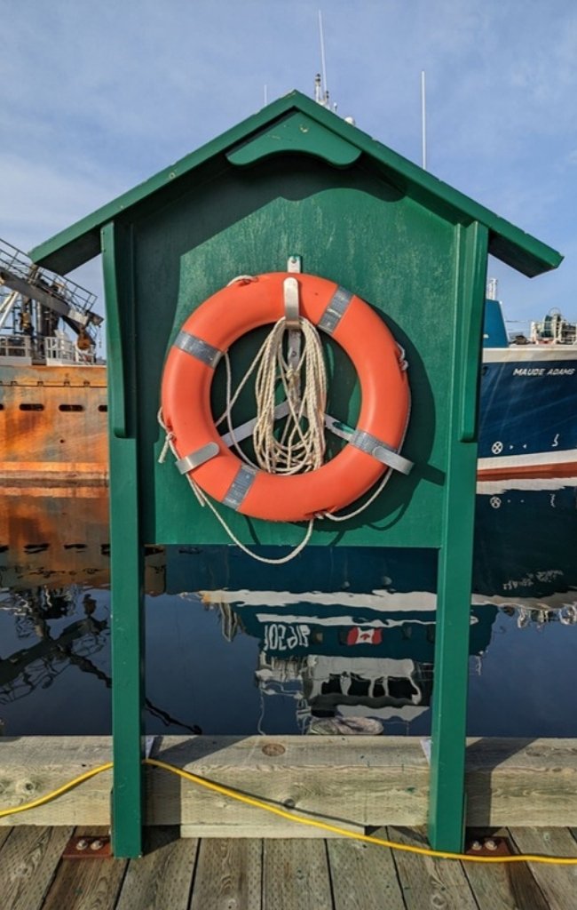 A lifebuoy on the wharf in Lunenburg harbor
