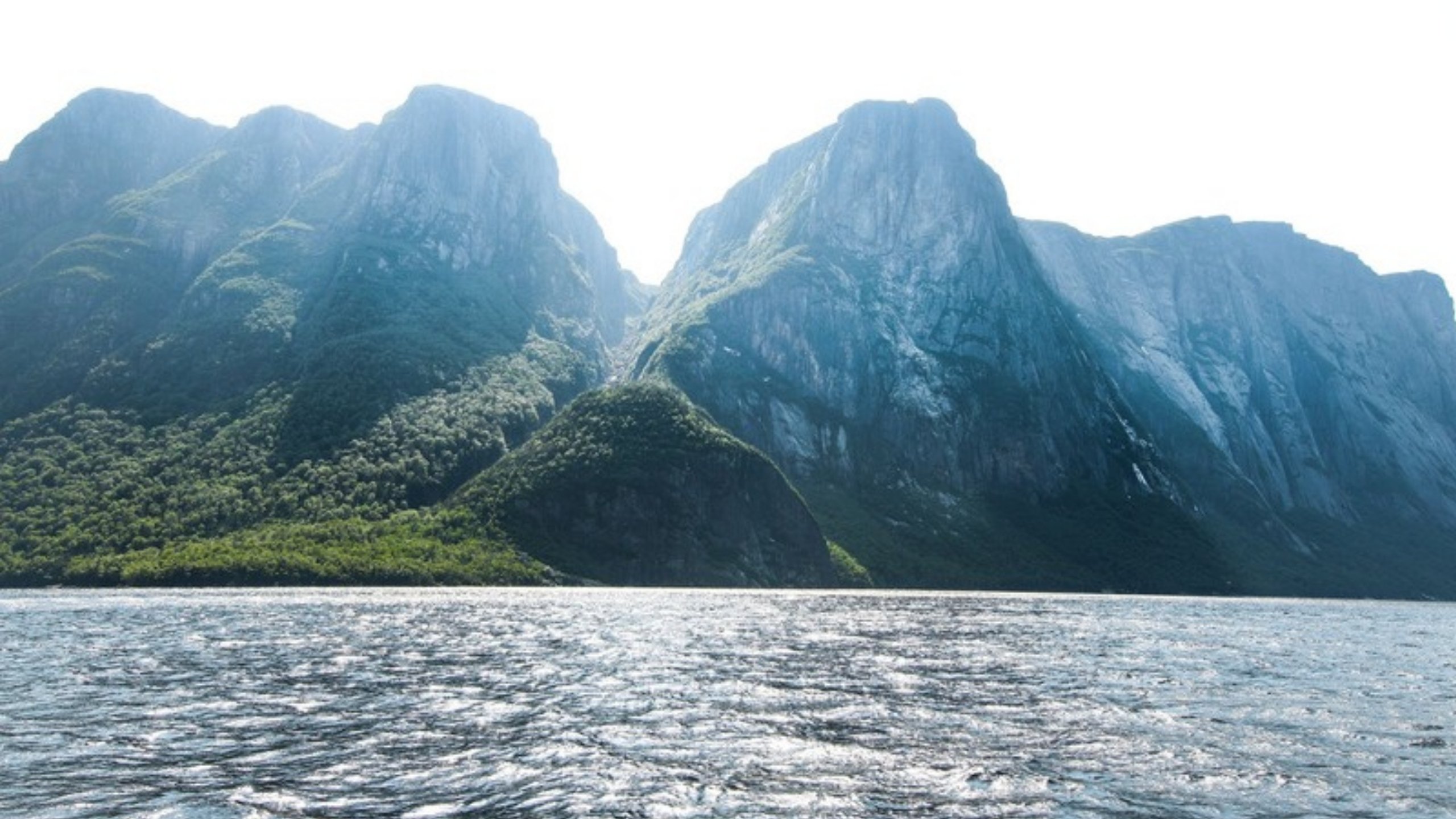 Green mountains rising above the sea in Gros Morne National Park