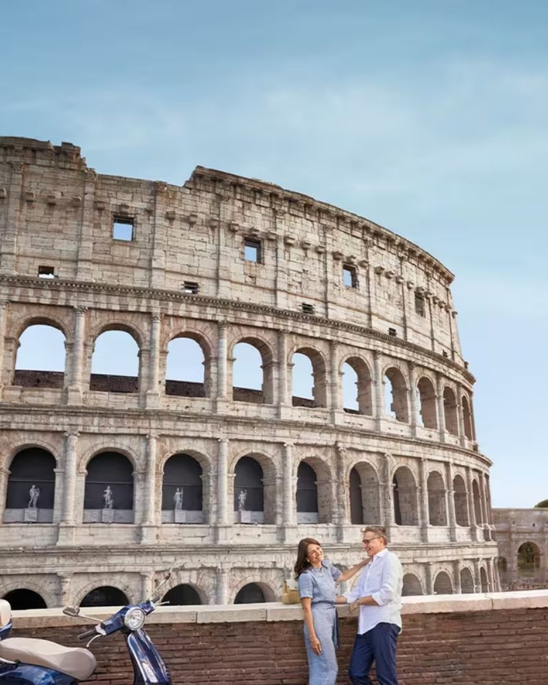 A couple in front of the Colosseum in Rome