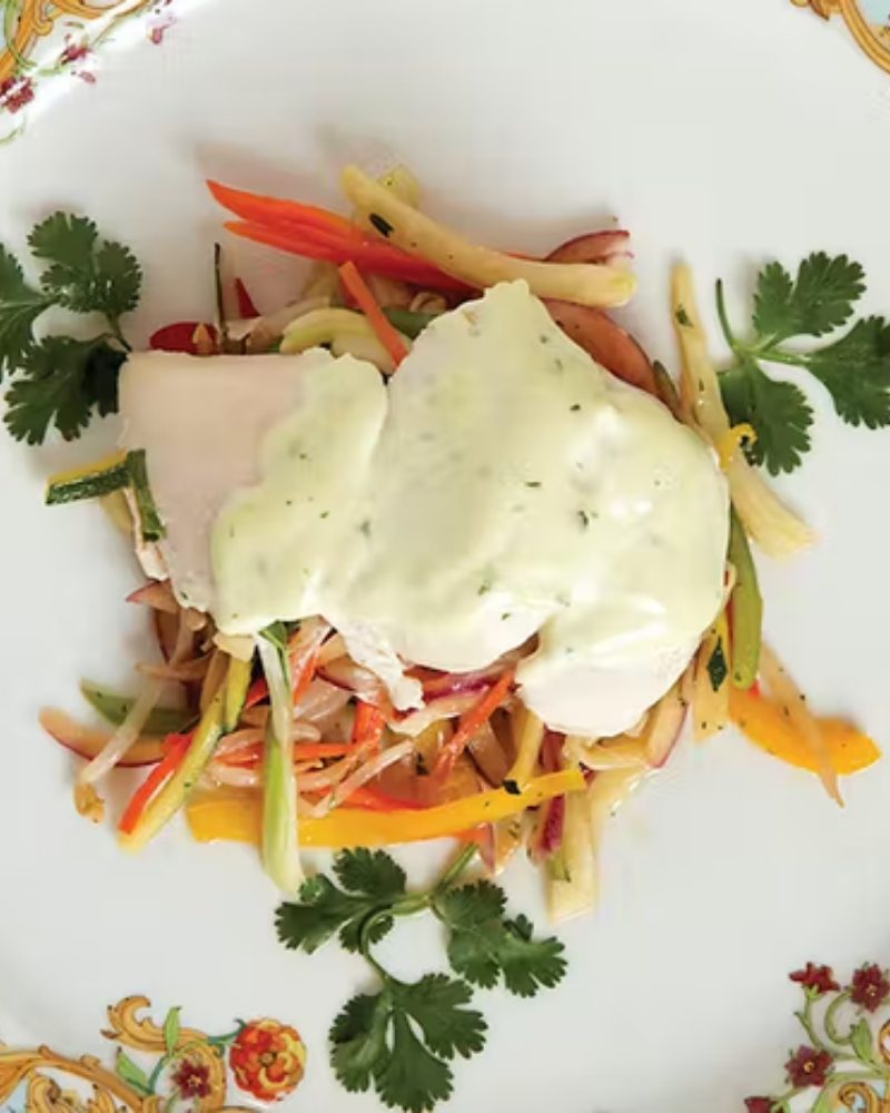 A plated fish dish with fresh cilantro