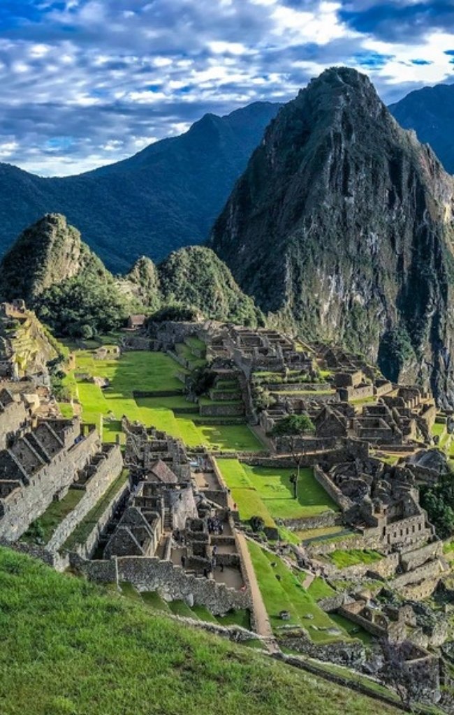 The ruins of Machu Picchu below green mountains