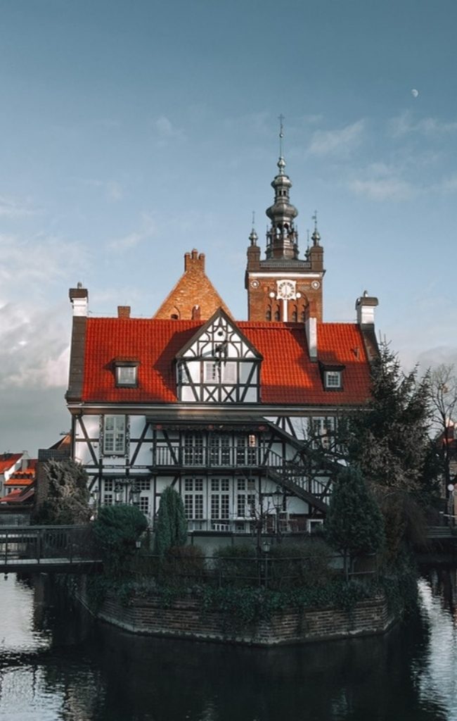 The medieval crane and waterfront houses of Gdansk reflected in the water