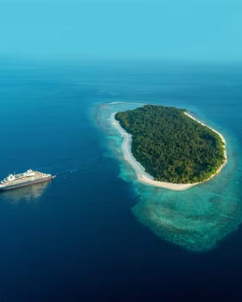 A PONANT ship beside a small island in the Maldives