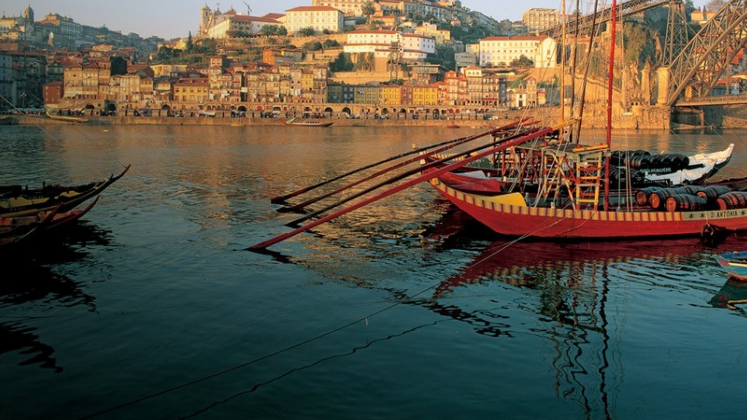 Traditional rabelo boats on the Douro River in Porto at sunset