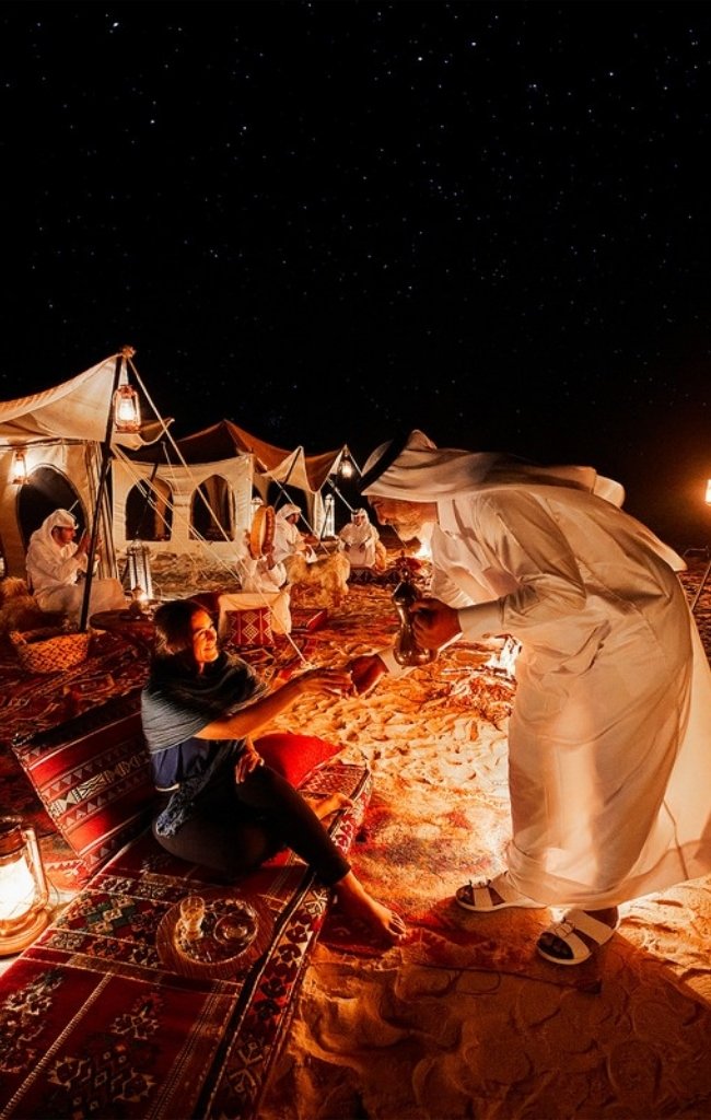 A lantern-lit desert camp at night