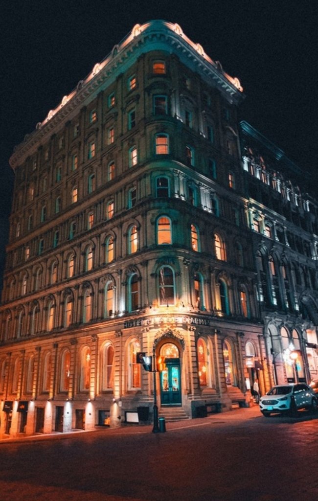 A historic stone building lit up at night in Montreal