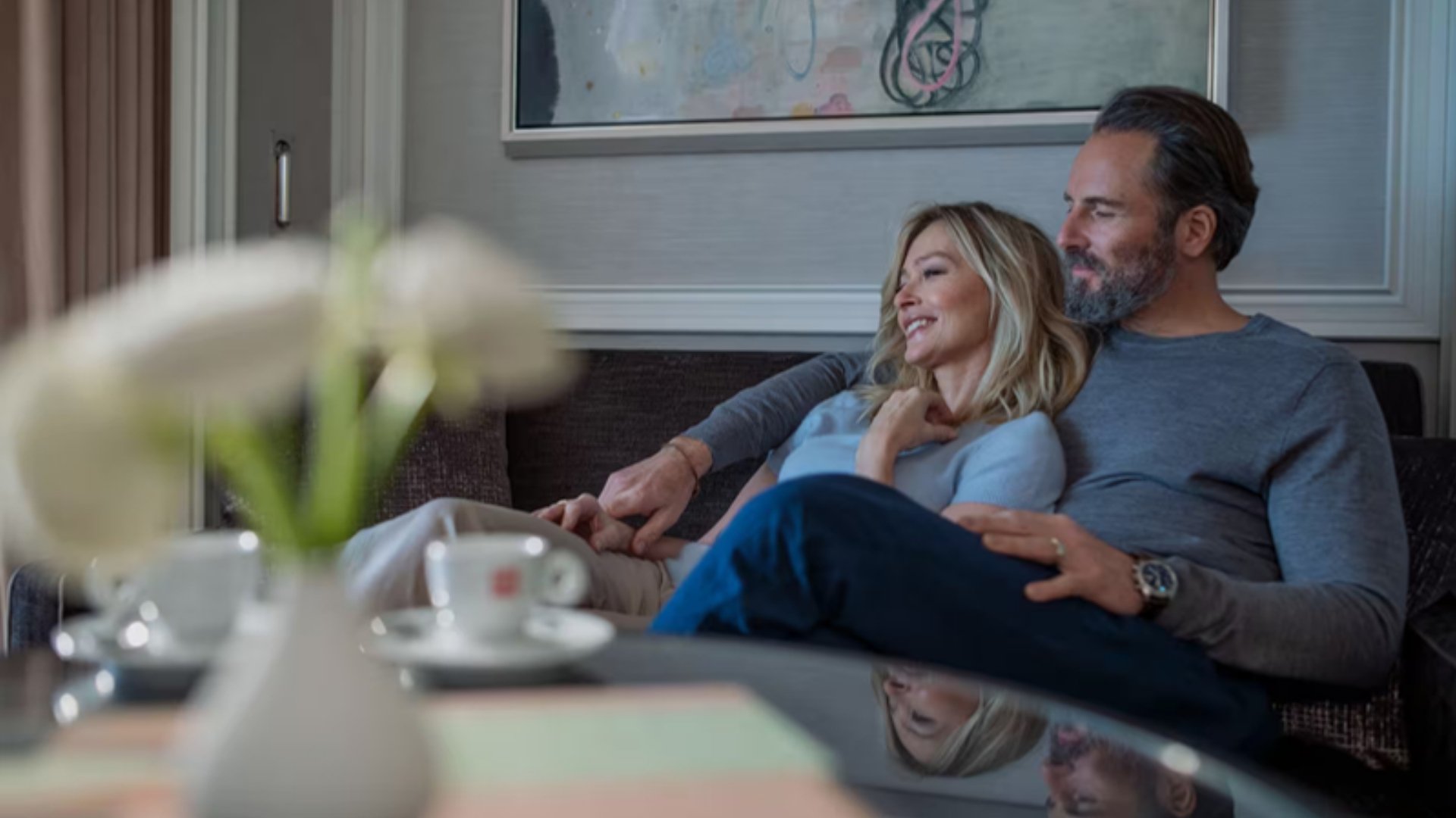 A couple relaxing in their suite aboard a Regent Seven Seas ship