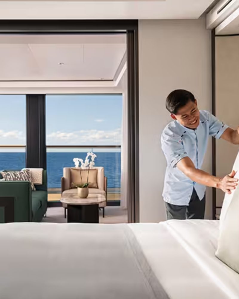A crew member preparing an ocean-view suite
