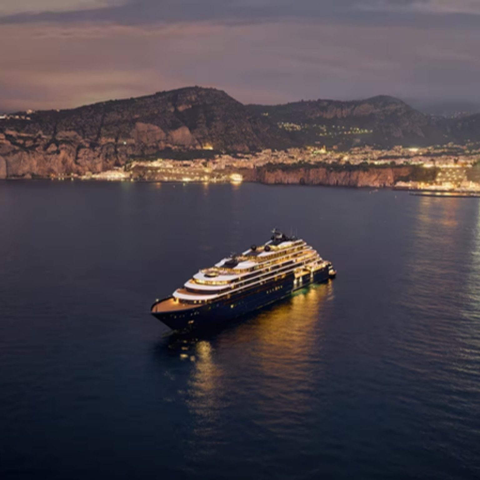 A Ritz-Carlton yacht at anchor off Sorrento at dusk