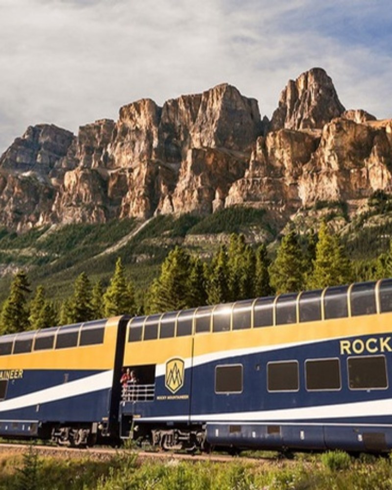 A Rocky Mountaineer train passing Castle Mountain in the Canadian Rockies