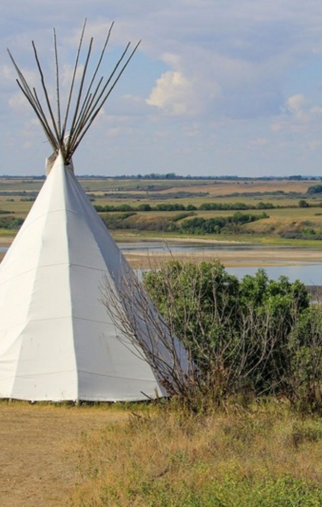 A teepee beside a calm northern lake