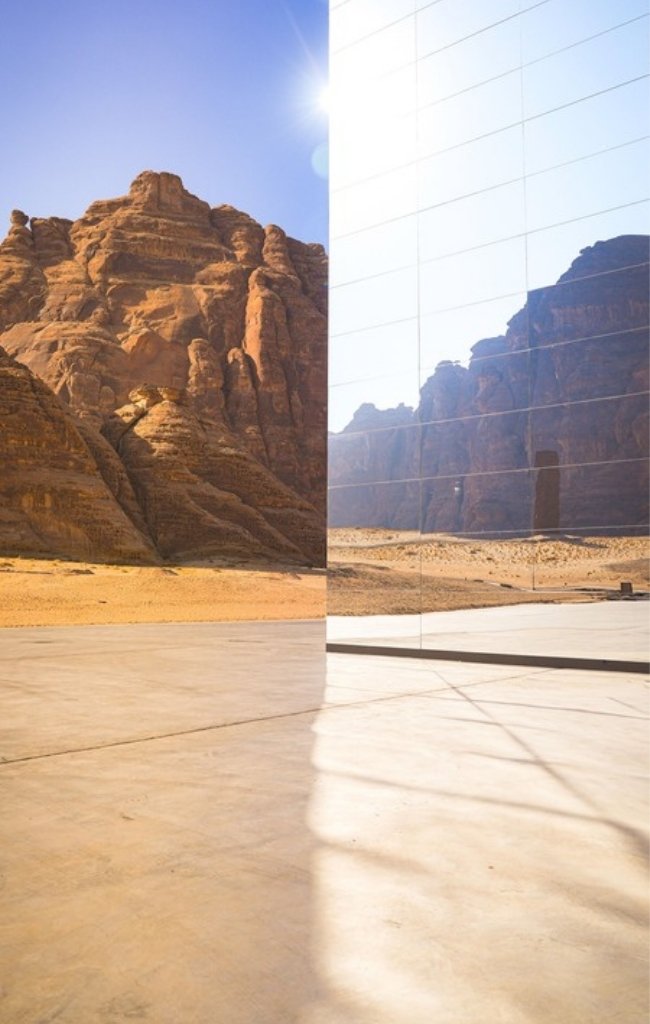 Desert cliffs reflected in the mirrored walls of Maraya in AlUla