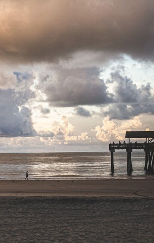 The Tybee Island pier under a golden sunrise sky