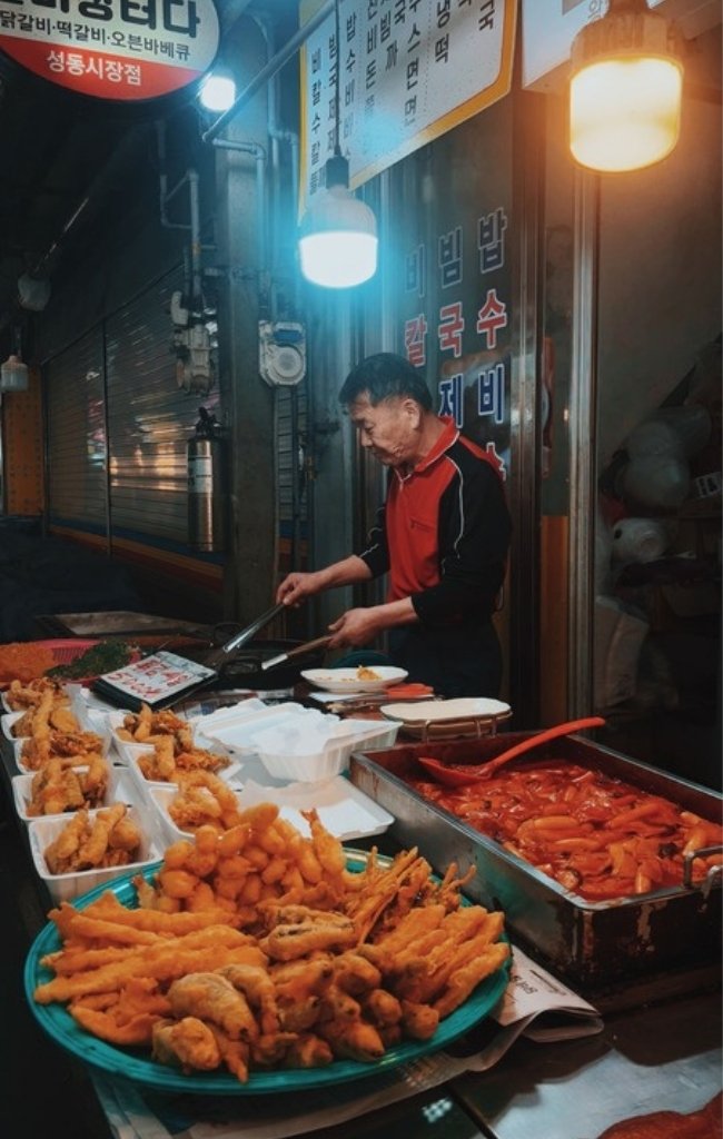 A night market vendor preparing street food