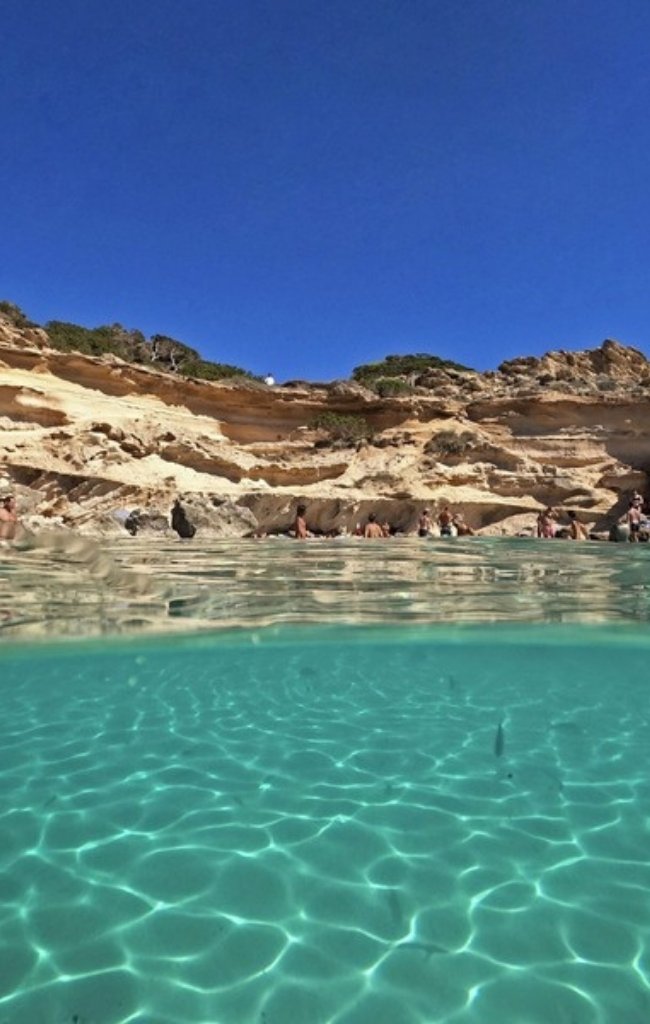 Clear turquoise water in a cove in the Balearic Islands