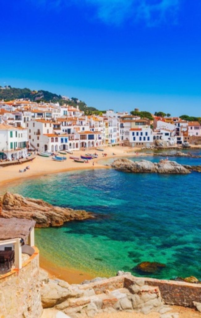 White houses above a turquoise bay at Calella de Palafrugell on the Costa Brava