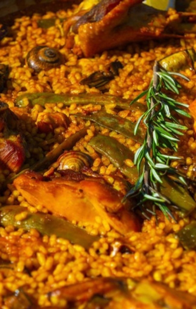 Traditional paella valenciana in the pan