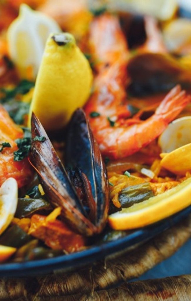 Seafood paella with prawns, mussels and lemon