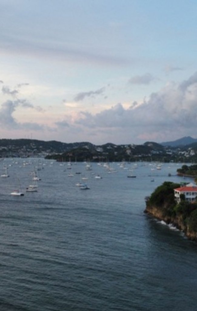 Boats anchored in a bay at twilight
