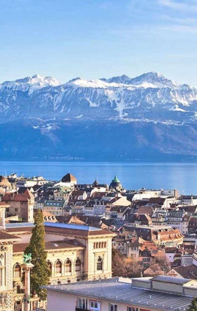 Rooftops of Lausanne above Lake Geneva and snowy Alps