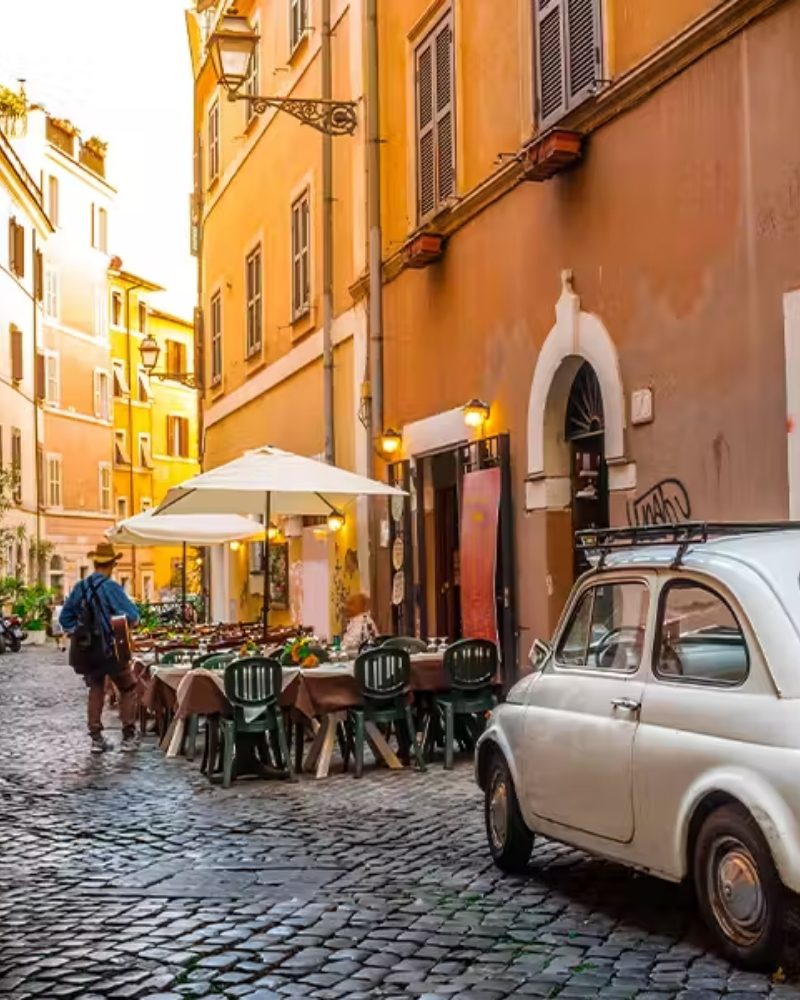 Café tables on a cobbled street in a Mediterranean town