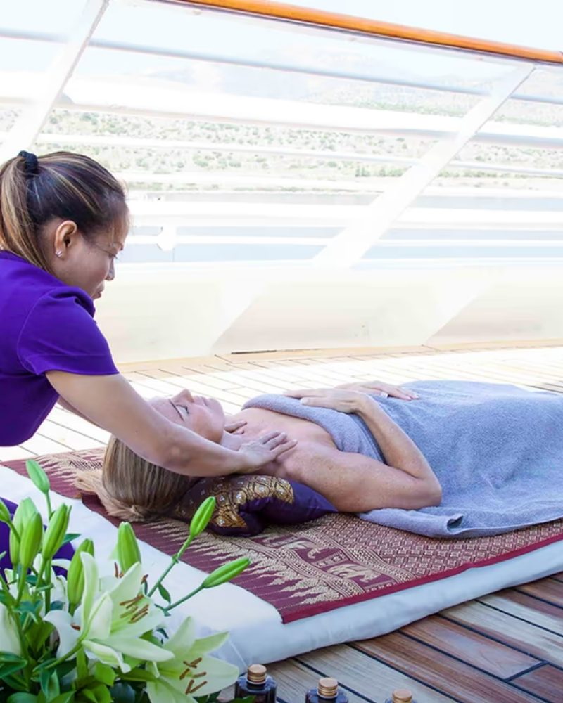 A guest receiving a massage on deck