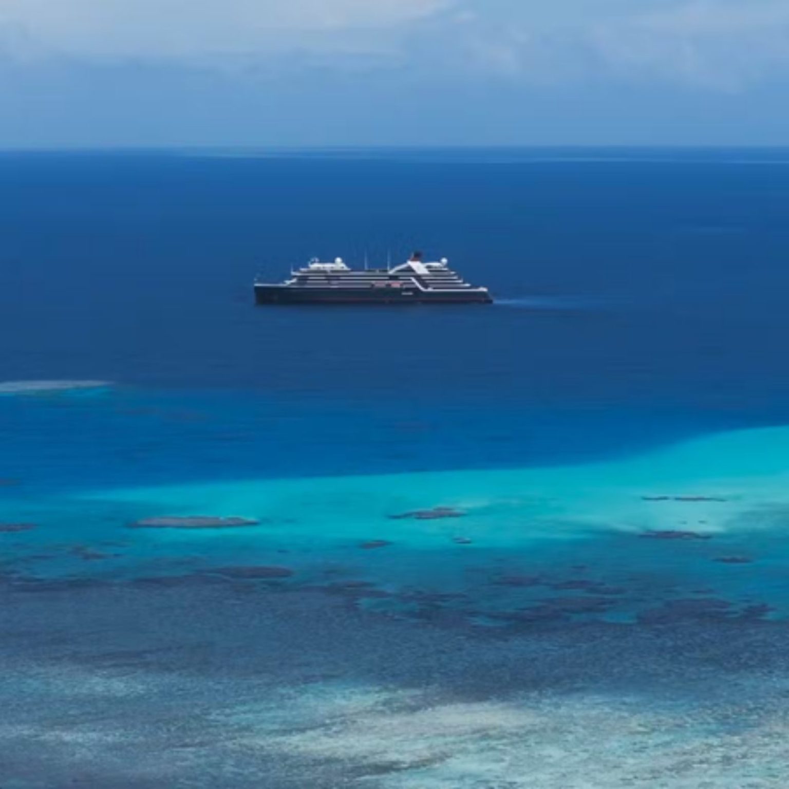 A Seabourn expedition ship anchored off a reef in the Solomon Islands