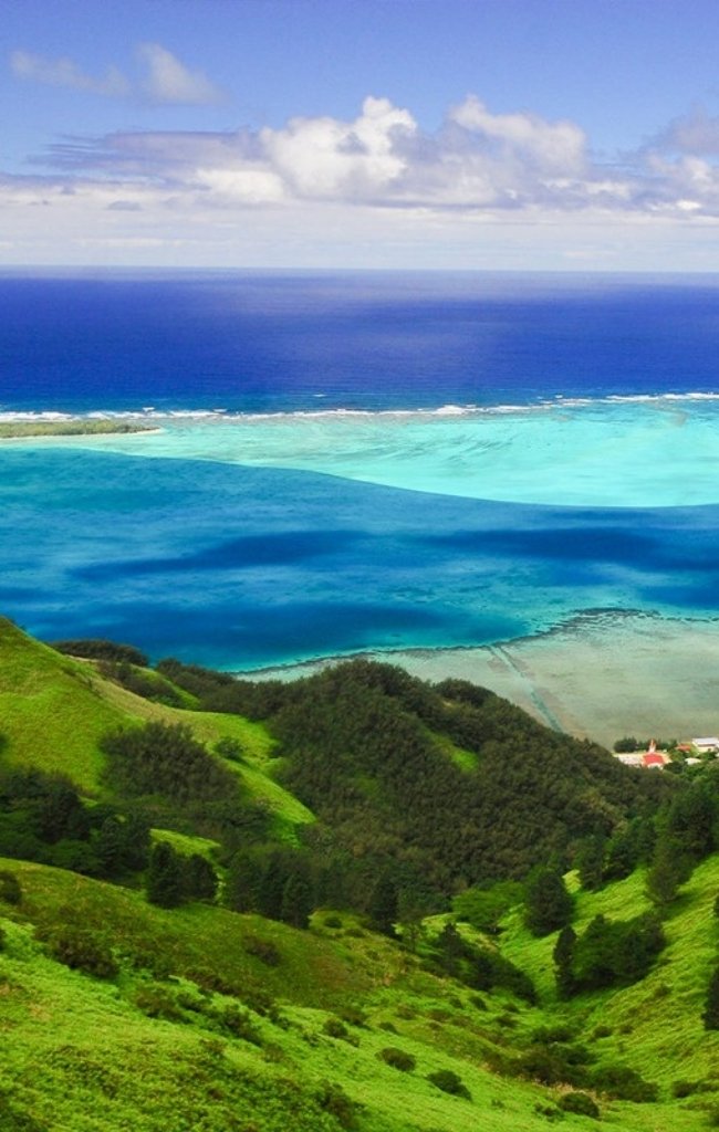 Green hills above a wide blue lagoon in the Austral Islands