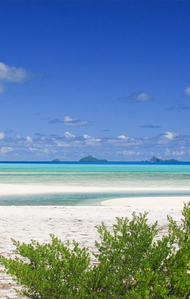 A white sand beach and shallow turquoise lagoon