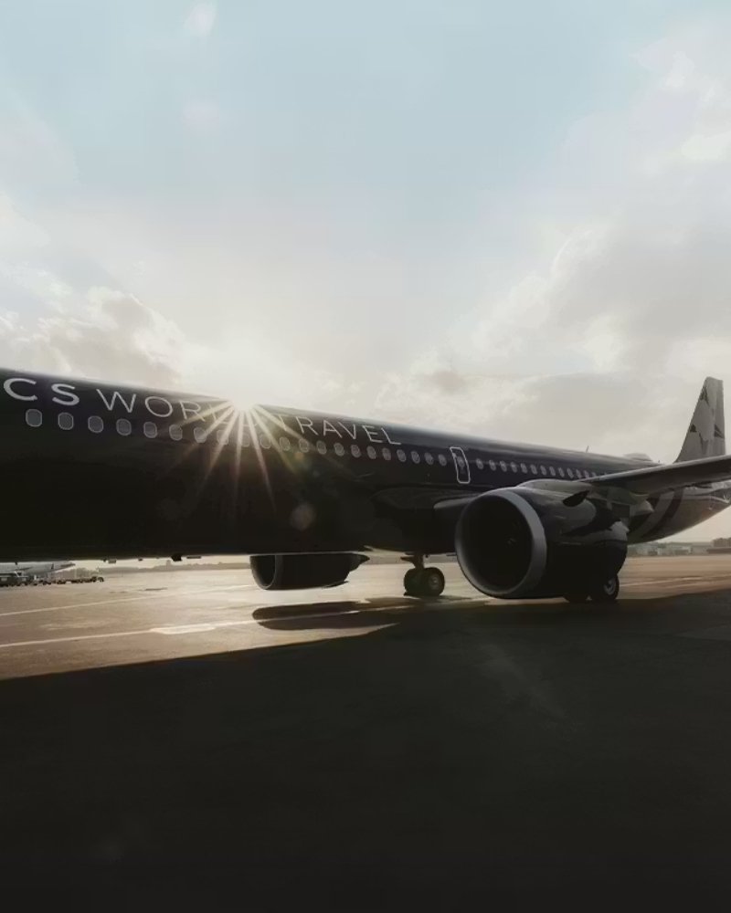 TCS World Travel private jet on the tarmac at sunrise