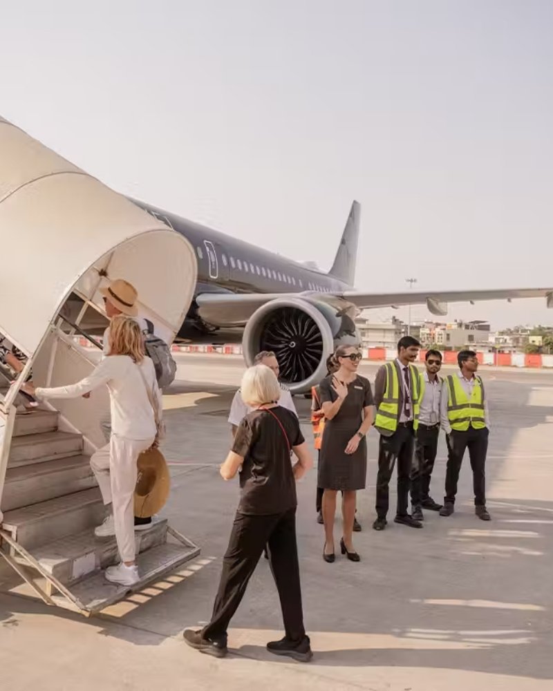Guests boarding a private jet greeted by the expedition crew