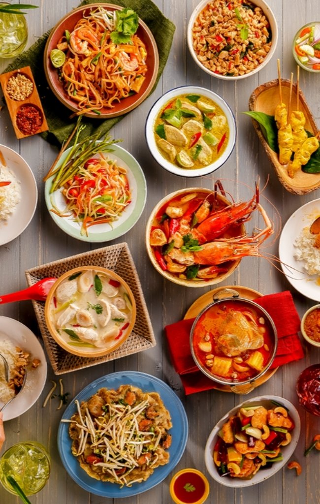 A table of Thai dishes shared among friends