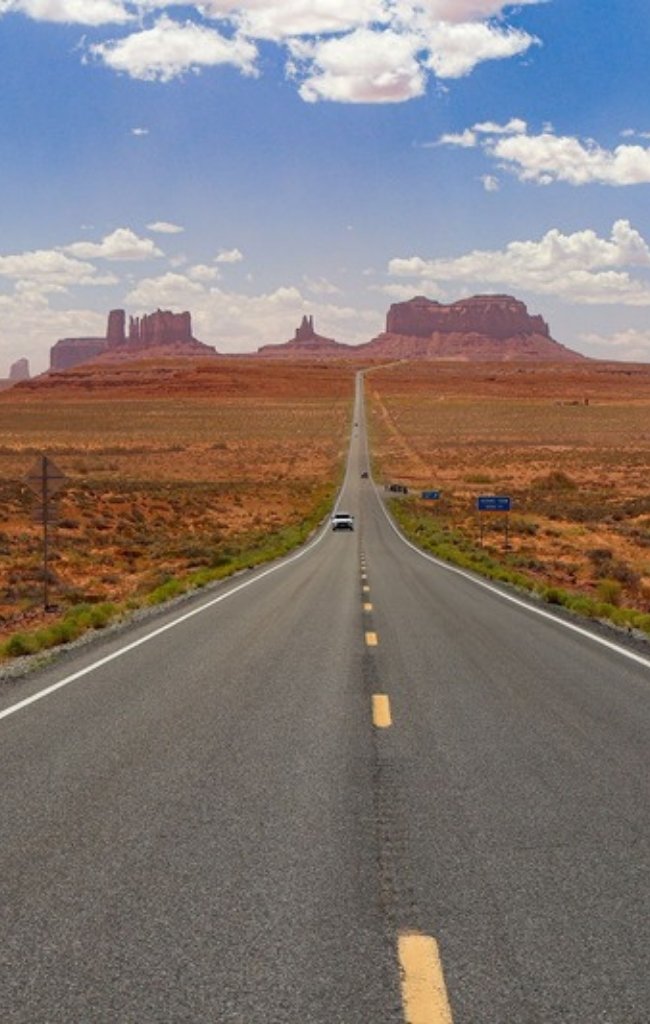 An open highway leading into Monument Valley