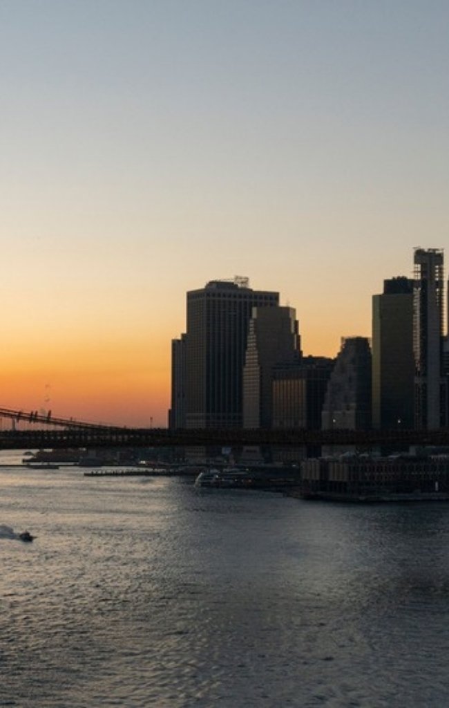 The Brooklyn Bridge and Manhattan skyline at sunset