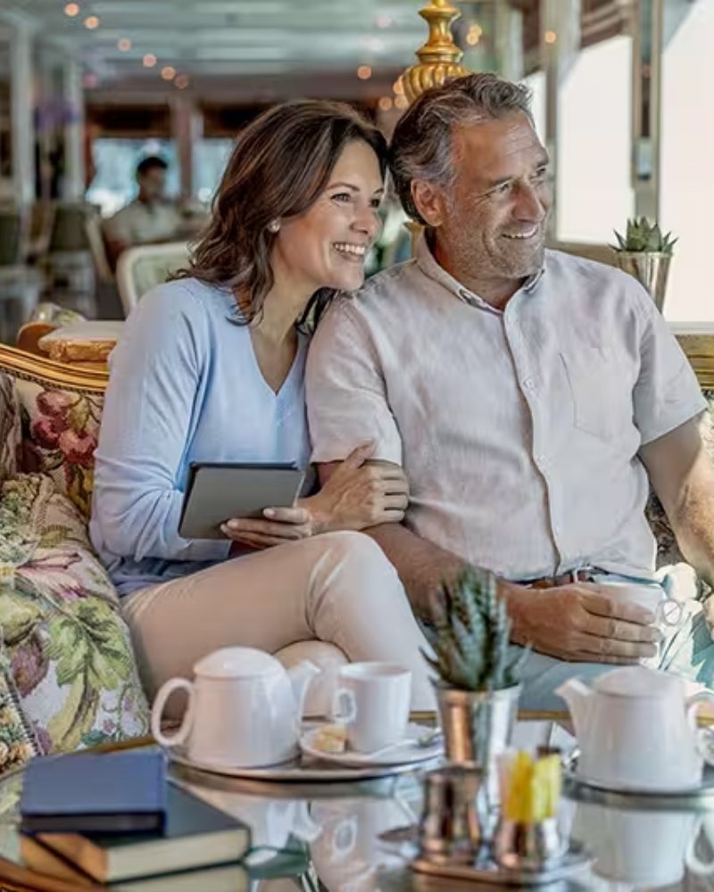A couple relaxing with coffee in a ship’s lounge