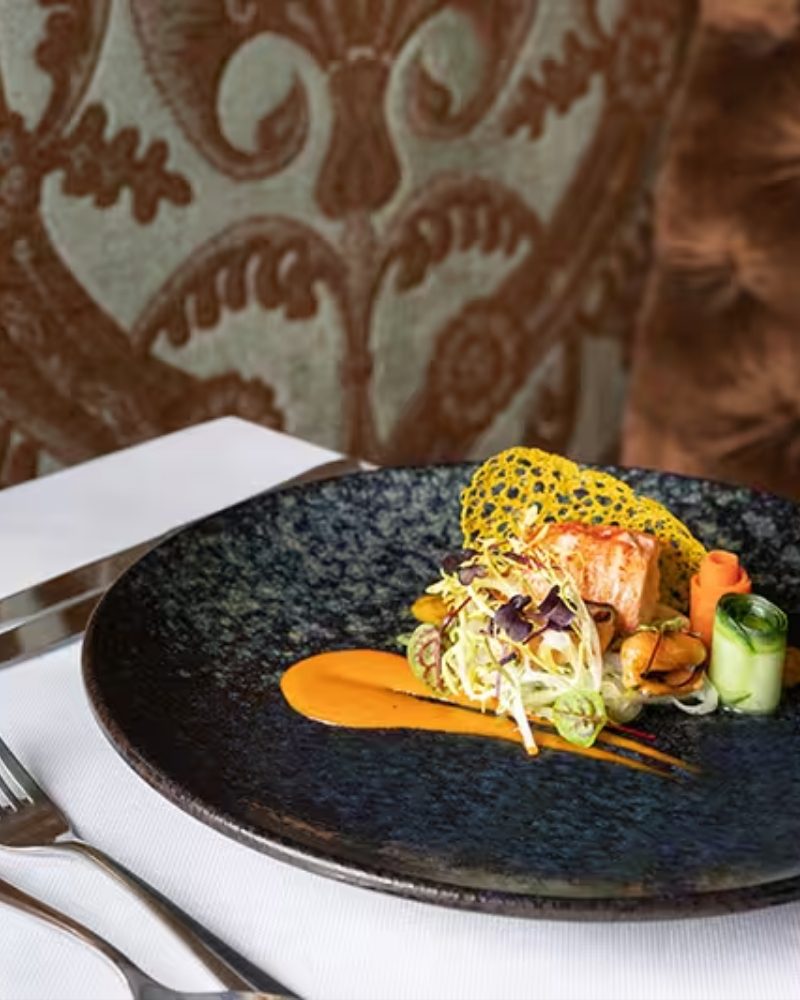 A plated fish dish in an elegant dining room
