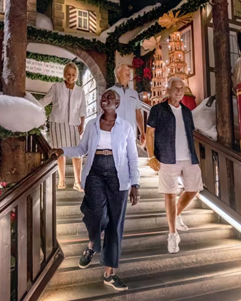 Friends walking down steps decorated for Christmas