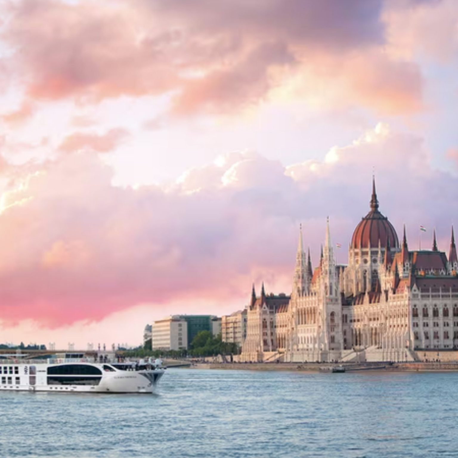 A Uniworld river ship on the Danube passing the Hungarian Parliament in Budapest