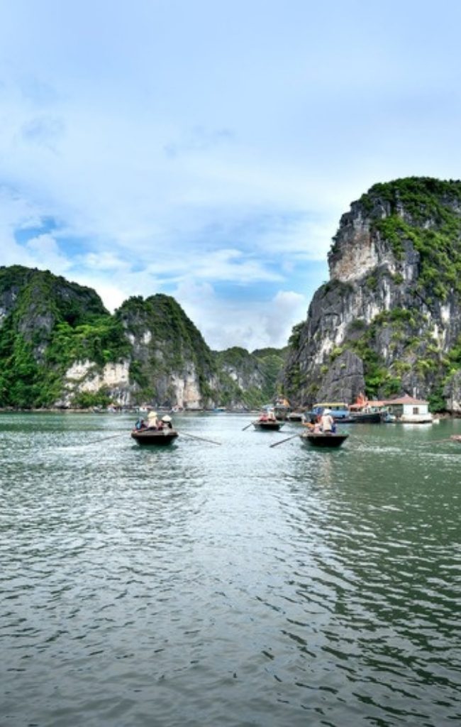 Boats among the limestone karsts of Ha Long Bay
