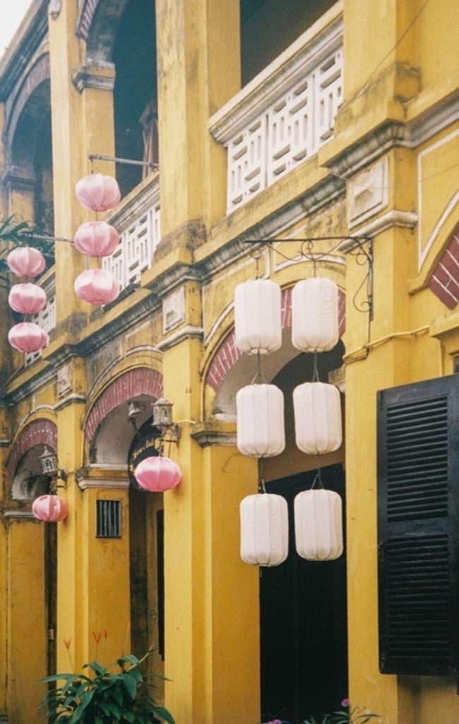 Colorful lanterns hanging on historic buildings in Hoi An