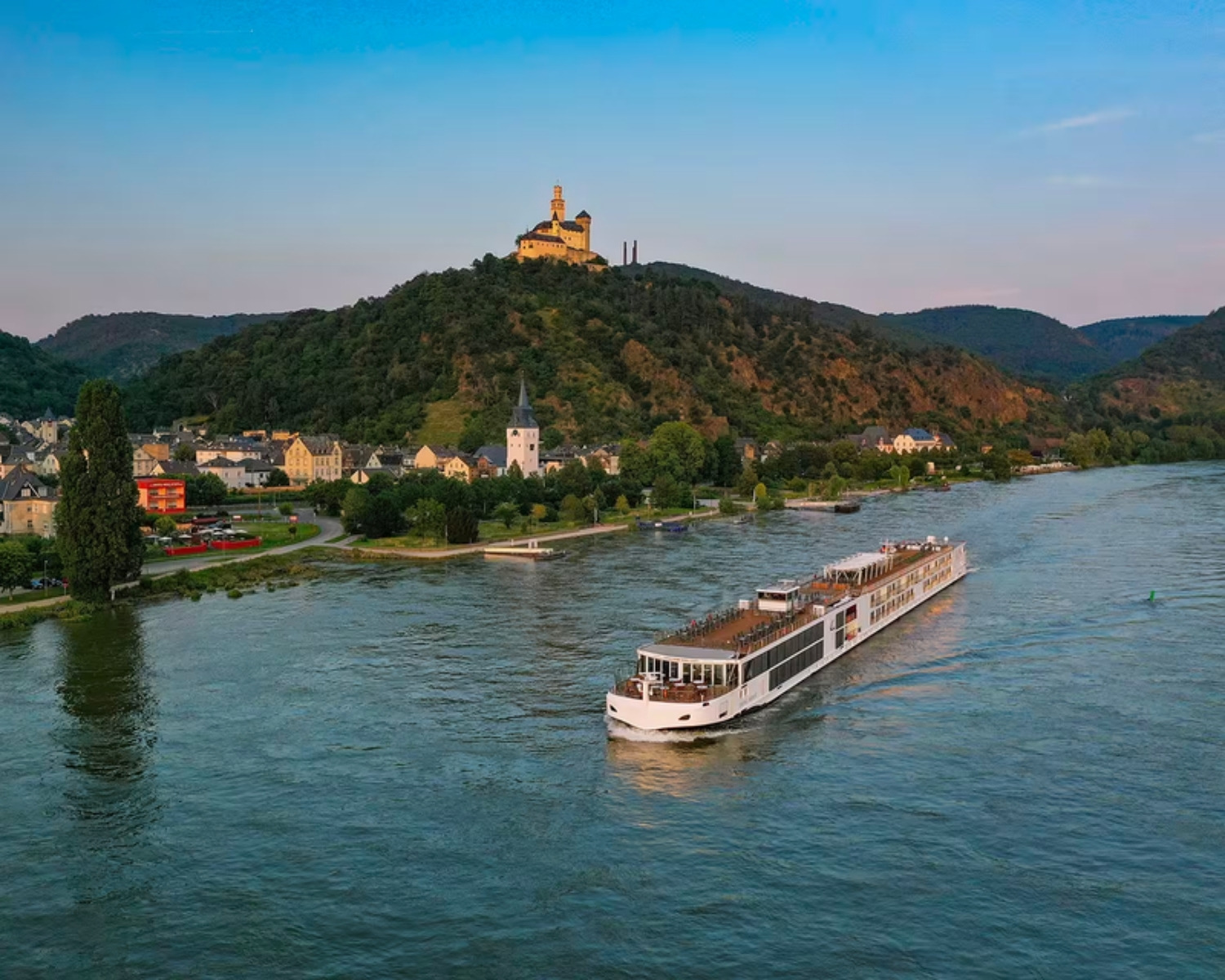 A Viking longship at sunset on the Rhine below Marksburg Castle
