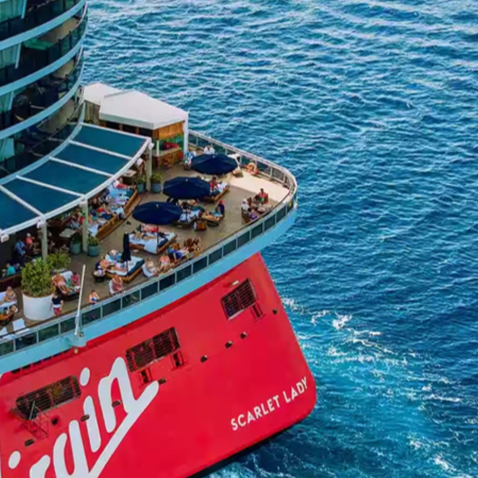 Aerial view of Scarlet Lady’s stern terrace above the sea