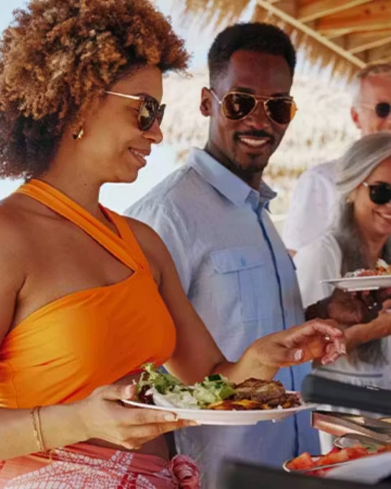 Guests serving themselves at a beach barbecue