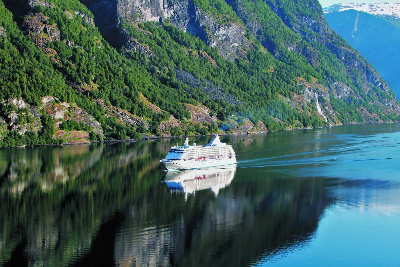 Seven Seas Voyager sailing through a fjord